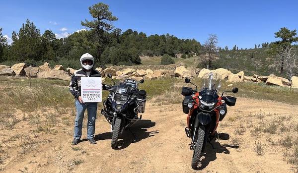 Andy holding a sign at the end of the accessible Old Raton Pass Road.